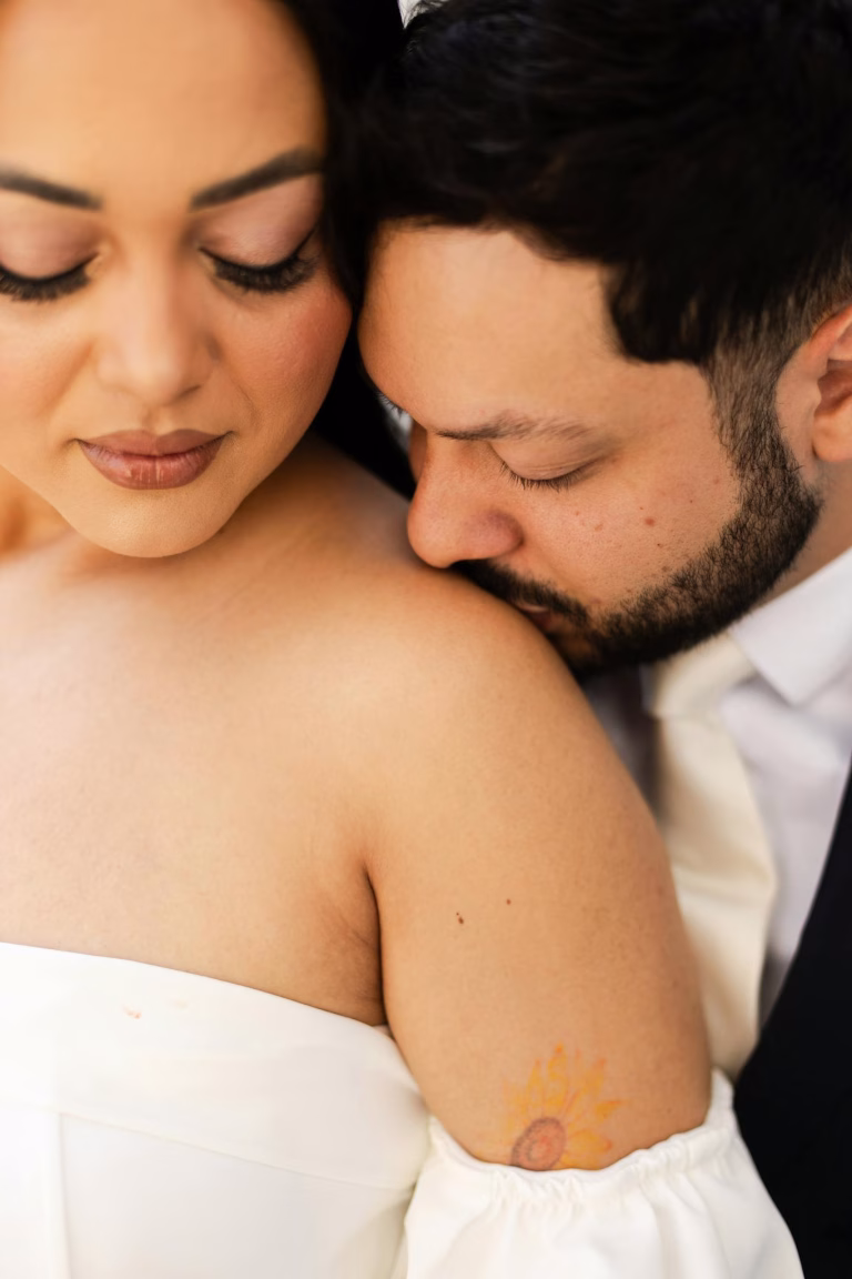 A loving embrace between a bride and groom, highlighting intimate connection on their wedding day.